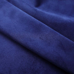 Close-up of navy blue velvet blackout curtain fabric with a soft, plush texture and metal rings.
