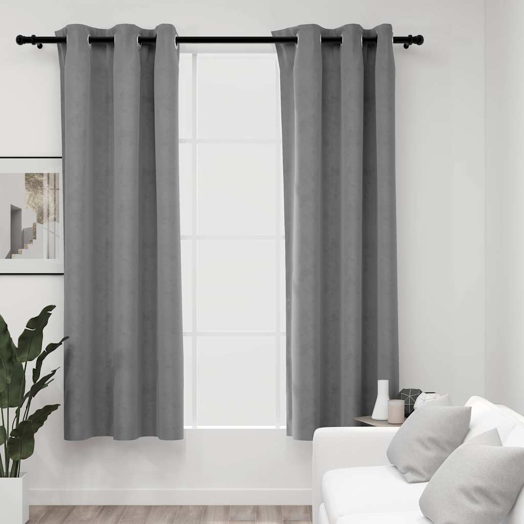 Two gray velvet blackout curtains, 37x95 inches, hung on a rod with rings in a bright living room.