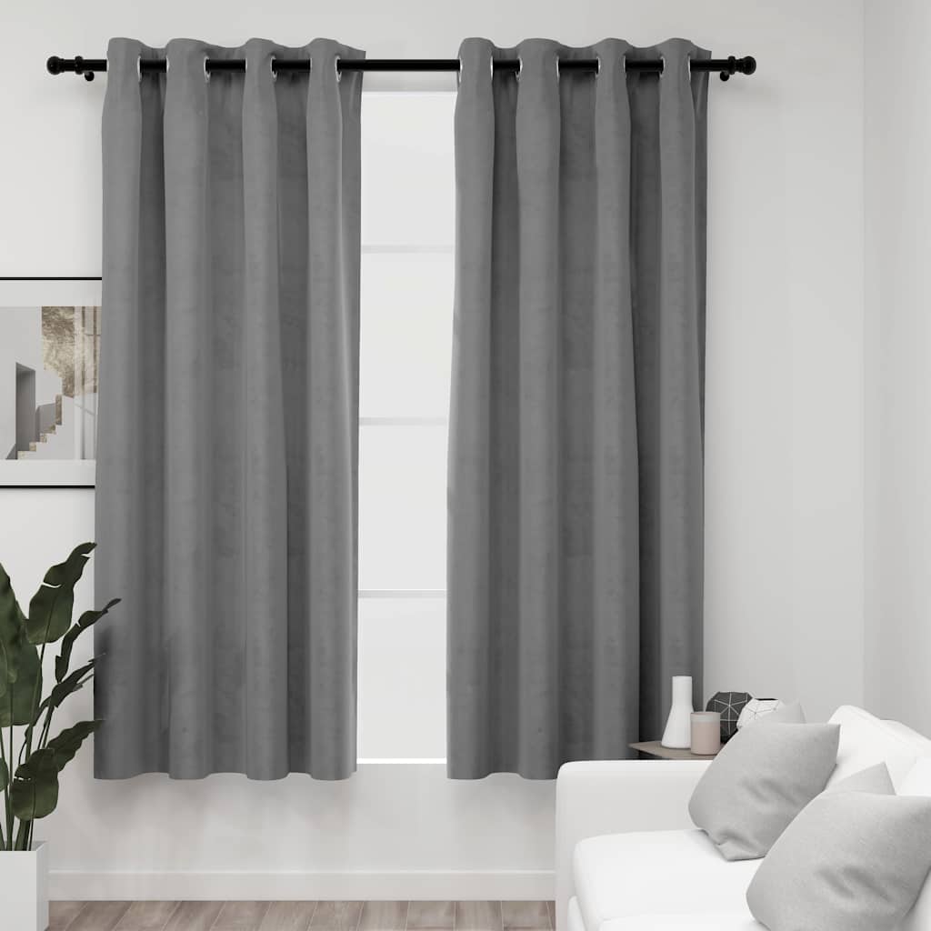 Two gray velvet blackout curtains, 54x63 inches each, hung on a rod with rings in a modern living room.