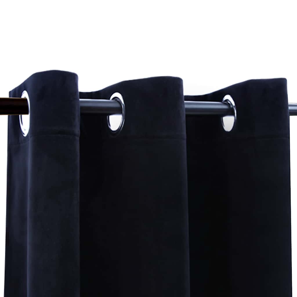 Two black velvet blackout curtain panels, 37x63 inches each, hung on a rod with rings.