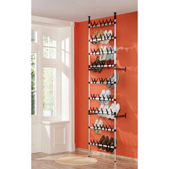 Silver and black telescopic aluminum shoe rack with rods, holding multiple pairs of shoes against a wall.