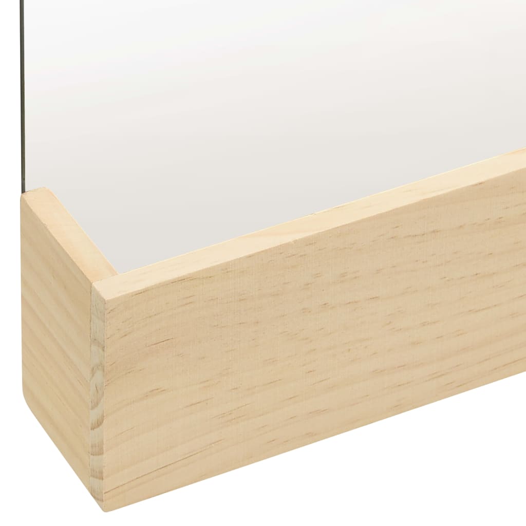 A close-up of a rectangular wall mirror with a light pinewood frame and storage ledge.