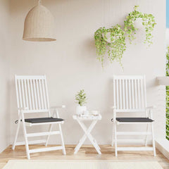 Two anthracite Oxford fabric garden chair cushions with black seats on white folding chairs.