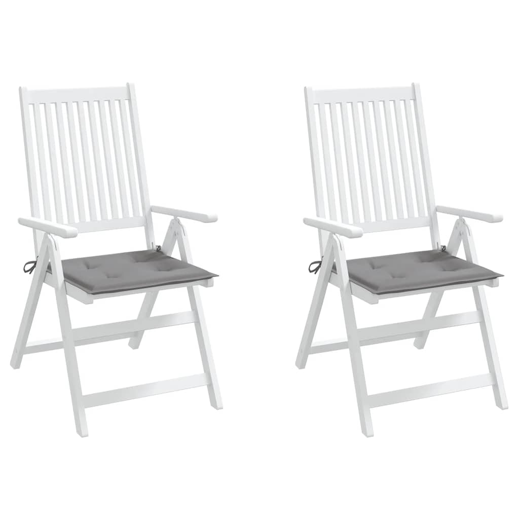 Two white wooden folding chairs with gray seat cushions are shown.