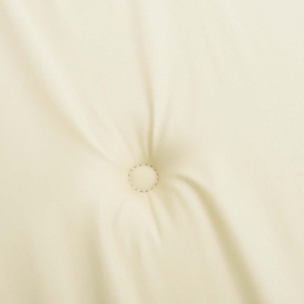 Cream deck chair cushion made of water-resistant Oxford fabric with tufted detailing.