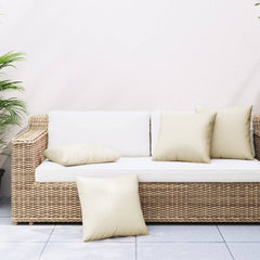 Cream polyester throw pillows in 4-pack, 19.7x19.7 inches, on wicker sofa.