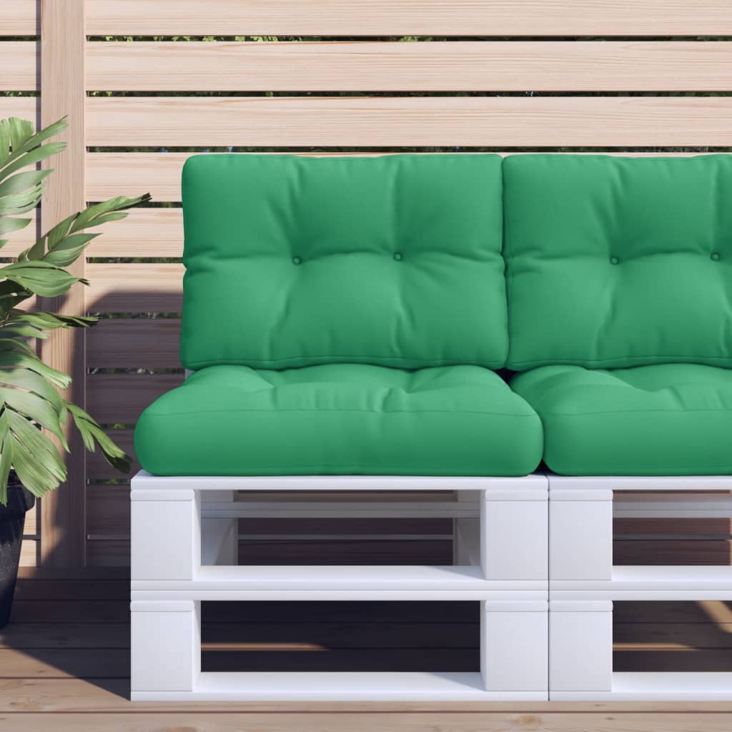 A two-piece set of green polyester cushions for a pallet sofa, featuring tufted seat and back pads on a white pallet against a wooden fence.
