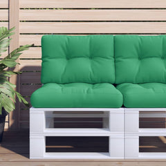 A two-piece set of green polyester cushions for a pallet sofa, featuring tufted seat and back pads on a white pallet against a wooden fence.