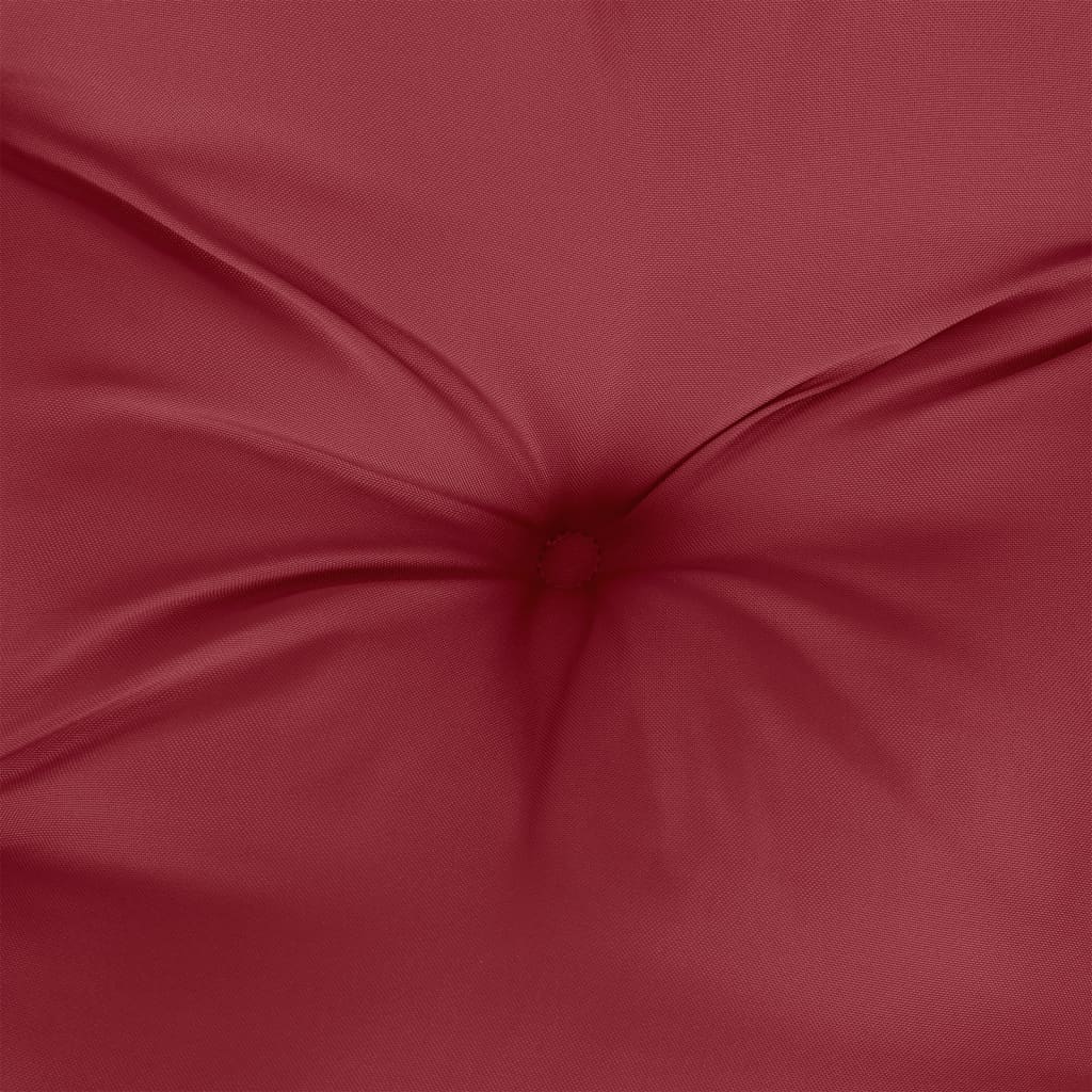 Close-up of a wine red tufted polyester cushion.