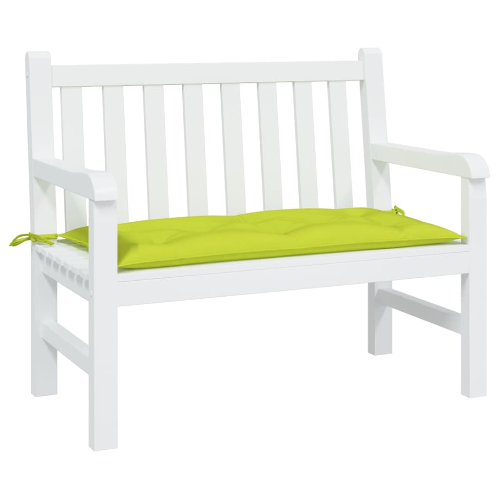 A bright green garden bench cushion with ties rests on a white wooden bench.
