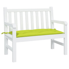 A bright green garden bench cushion with ties rests on a white wooden bench.