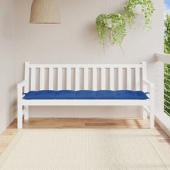 White garden bench with blue Oxford fabric cushion on a sunny balcony.