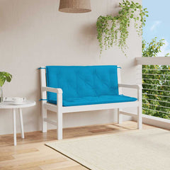 A light blue garden bench cushion is tied to a white wooden bench on a patio.