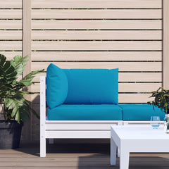 A light blue 3-piece pallet cushion set on a white outdoor sofa.