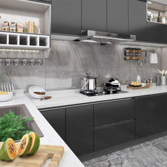 Modern black kitchen with glossy cabinets, stainless appliances, and white countertop.