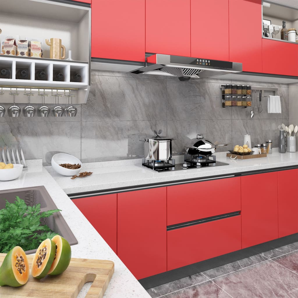 Red PVC self-adhesive film applied to modern kitchen cabinets and surfaces.