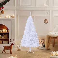A 4-foot white artificial Christmas tree with thick PVC branches stands in a cozy living room.