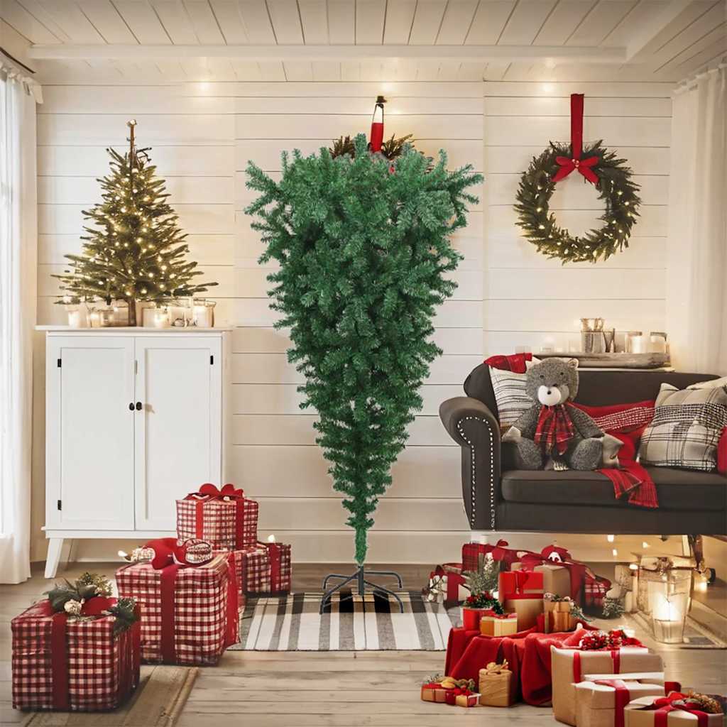 A 6-foot green artificial upside-down Christmas tree on a stand in a cozy holiday living room with gifts and decorations.