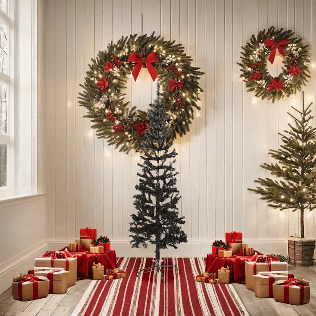 A 5 ft slim black artificial Christmas tree stands in a white room with red gifts and wreaths.