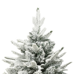 A close-up of the top of a flocked artificial Christmas tree with green needles.
