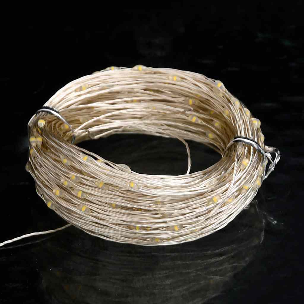 Coiled 49.2ft warm white LED string lights with 150 LEDs on copper wire.