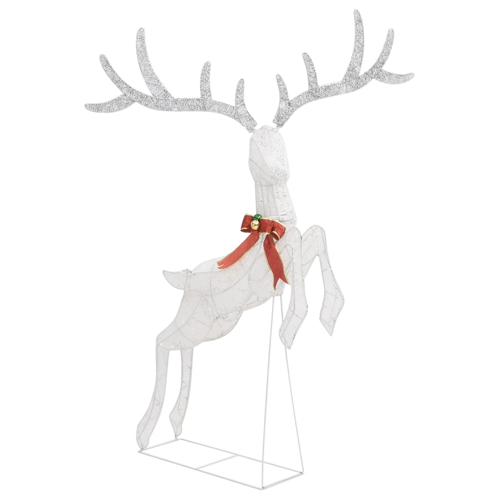 A white flying reindeer Christmas decoration with glitter antlers and a red bow.