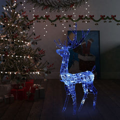 4ft blue LED-lit acrylic reindeer Christmas decoration standing by a tree.