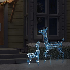 Acrylic reindeer family decoration with 160 cold white LEDs, shown lit outdoors near a house.