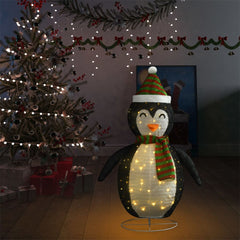 A 4ft black and white LED-lit fabric snow penguin figure with Santa hat and scarf, posed near a Christmas tree.