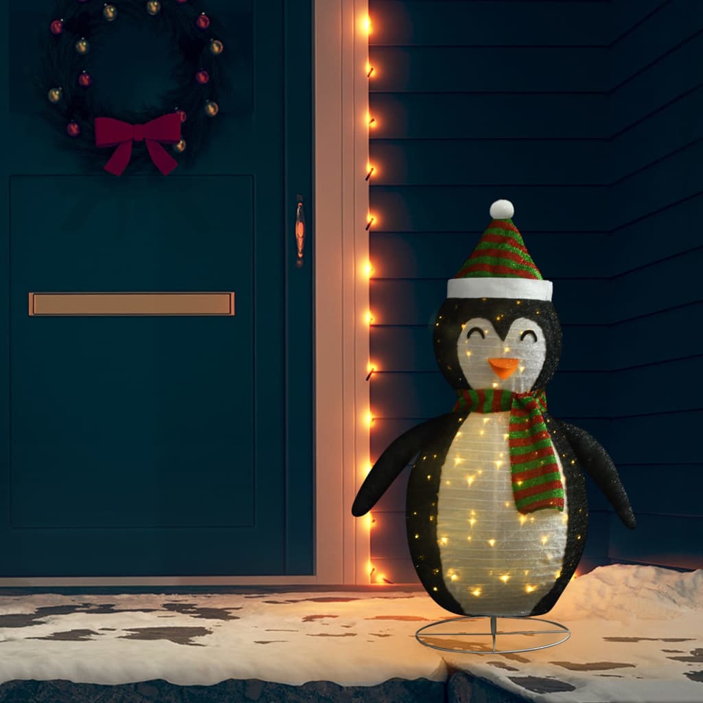 4ft LED snow penguin figure in black and white fabric with green scarf and hat, standing on snowy porch.