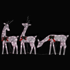 Three golden lighted reindeer with red bows and warm white LEDs on a black background.