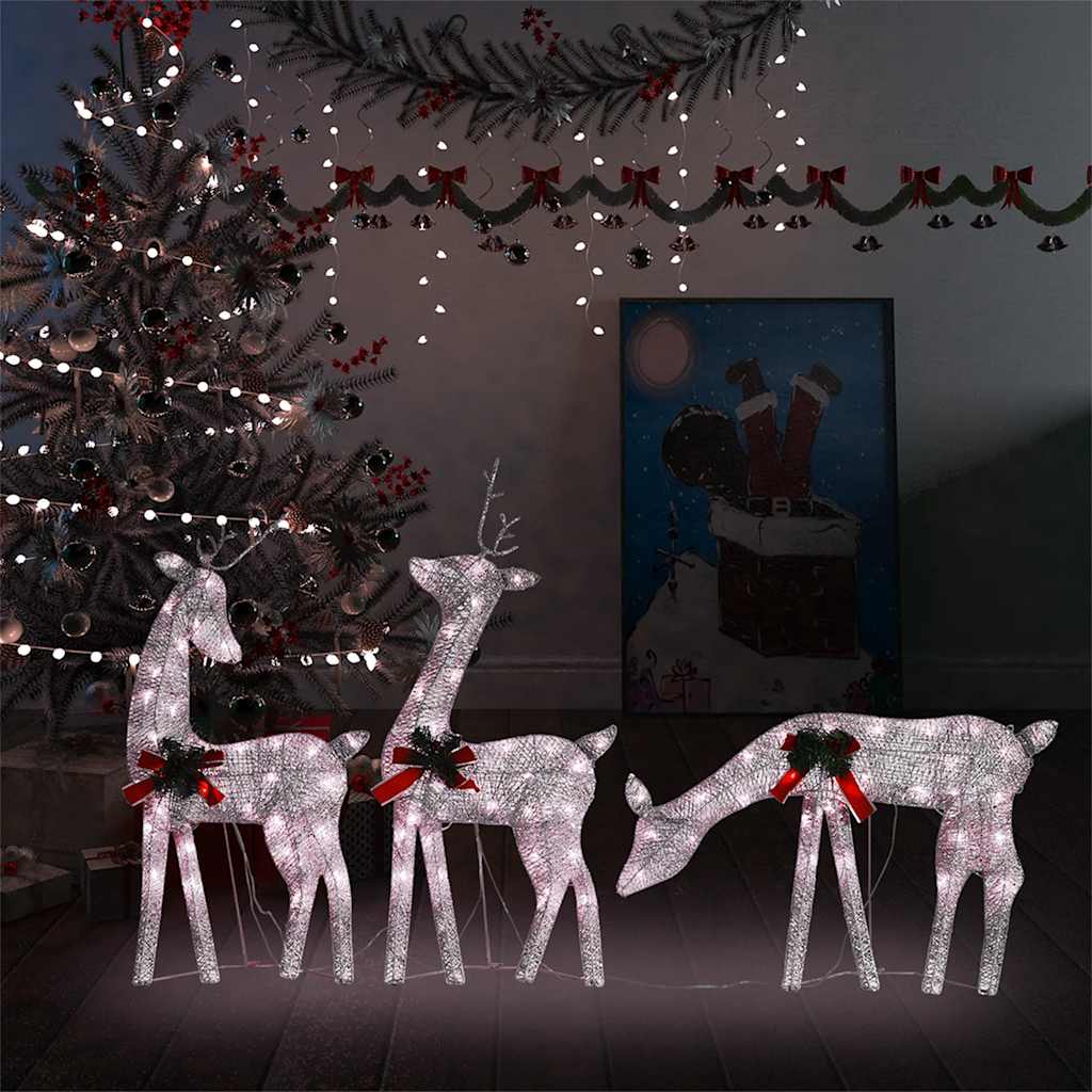 Lighted gold reindeer family decor with warm white LEDs and red bows.
