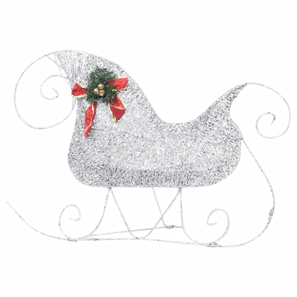 A silver glitter Christmas sleigh decoration with a red and green holly bow.