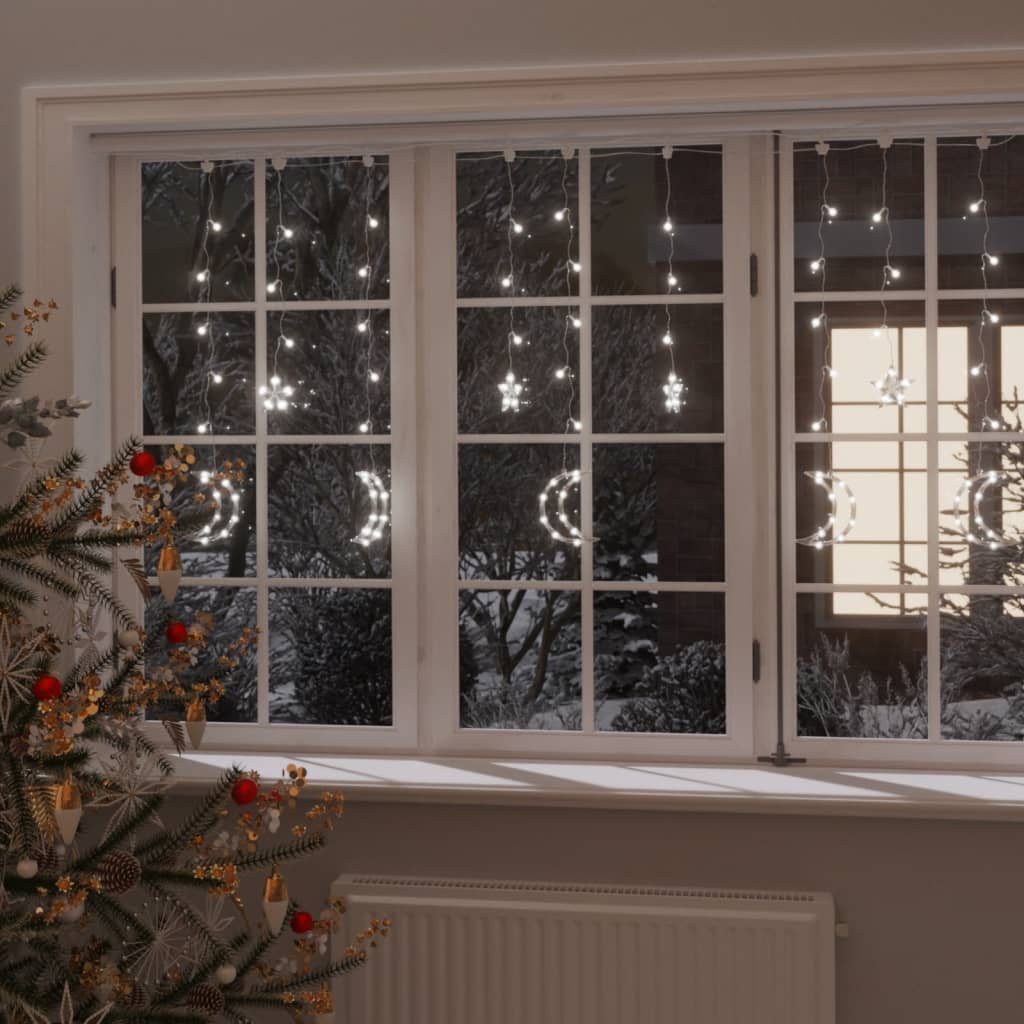 White LED fairy lights in star and moon shapes draped over a window with Christmas tree.
