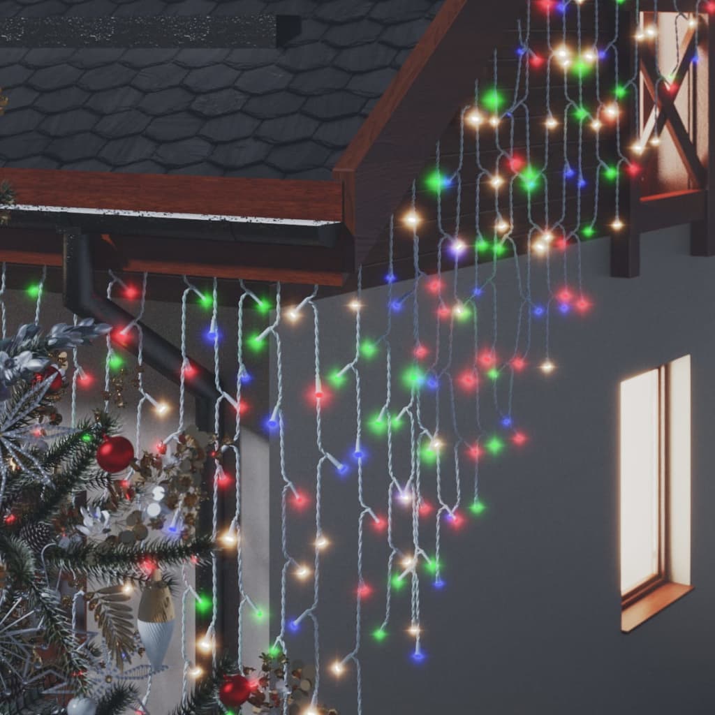 Colorful LED curtain icicle lights with 400 bulbs draped over a house roof and window.