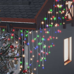 Colorful LED curtain icicle lights with 400 bulbs draped over a house roof and window.