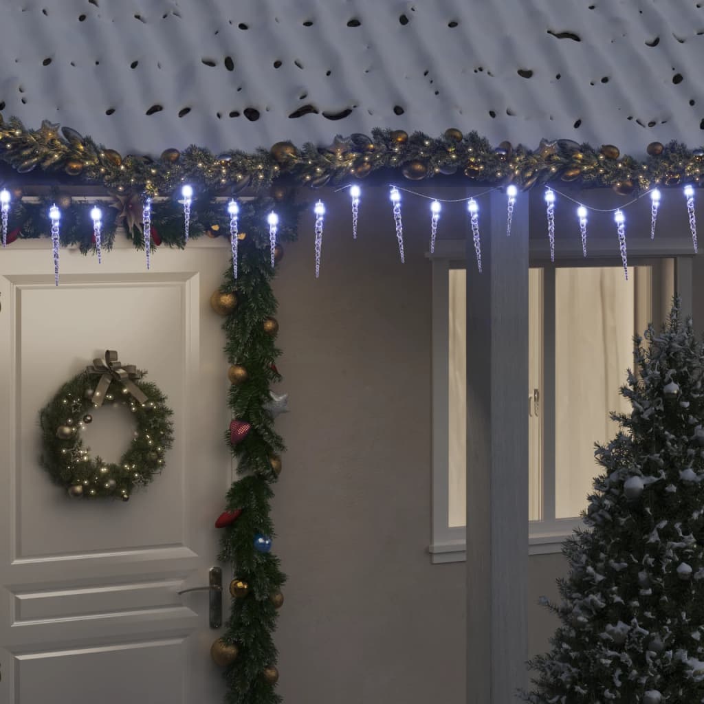 Icicle LED Christmas lights in cold white, 100 LEDs on a snowy house roof.