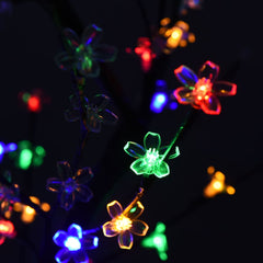 A 4ft cherry blossom Christmas tree with 128 colorful LEDs illuminating soft pink petals on black branches.