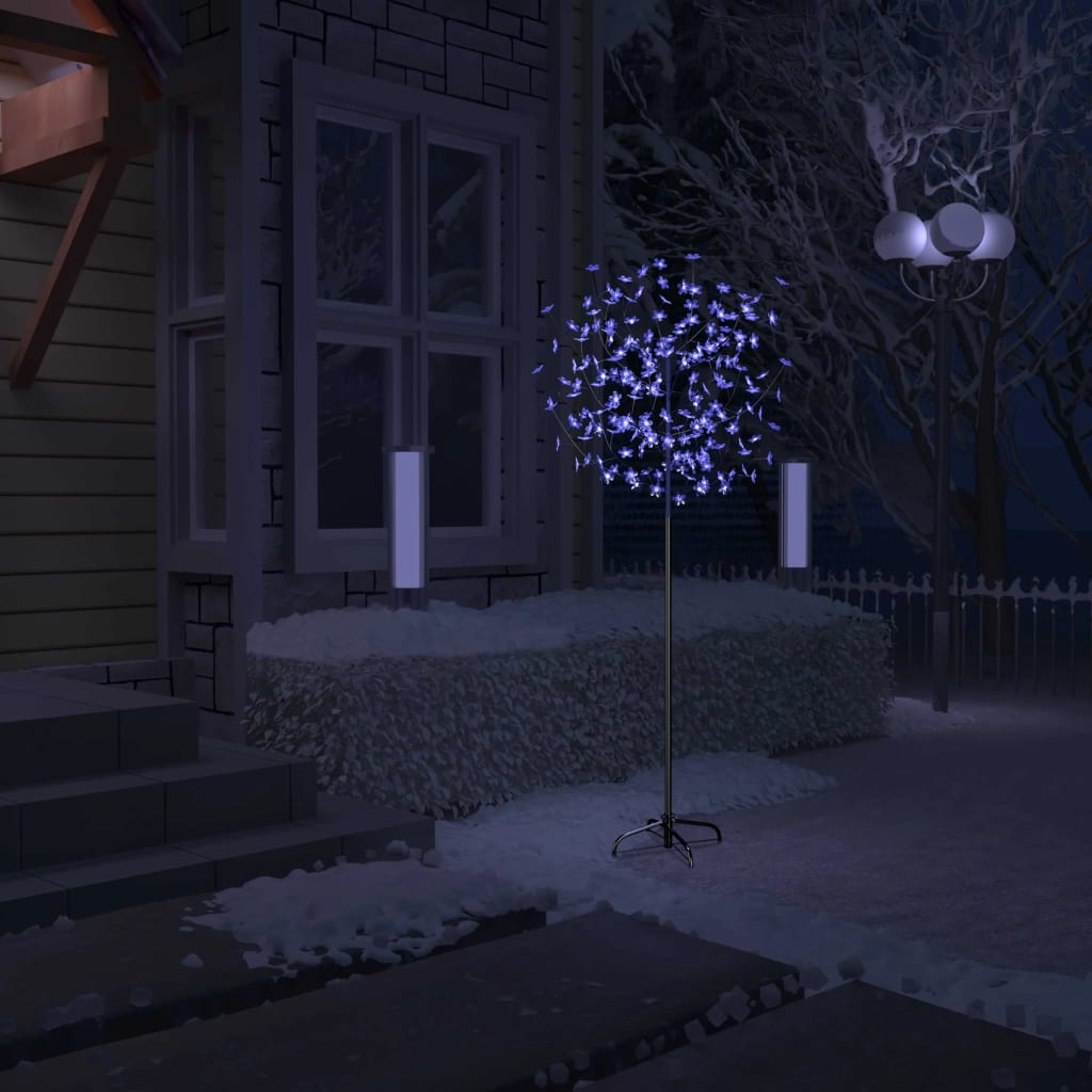 A 6 ft cherry blossom Christmas tree with 200 blue-white LEDs, lit in a snowy outdoor scene.