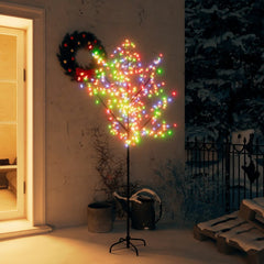 A 6ft cherry blossom Christmas tree with 200 colorful LEDs, standing on a metal base outdoors at night.