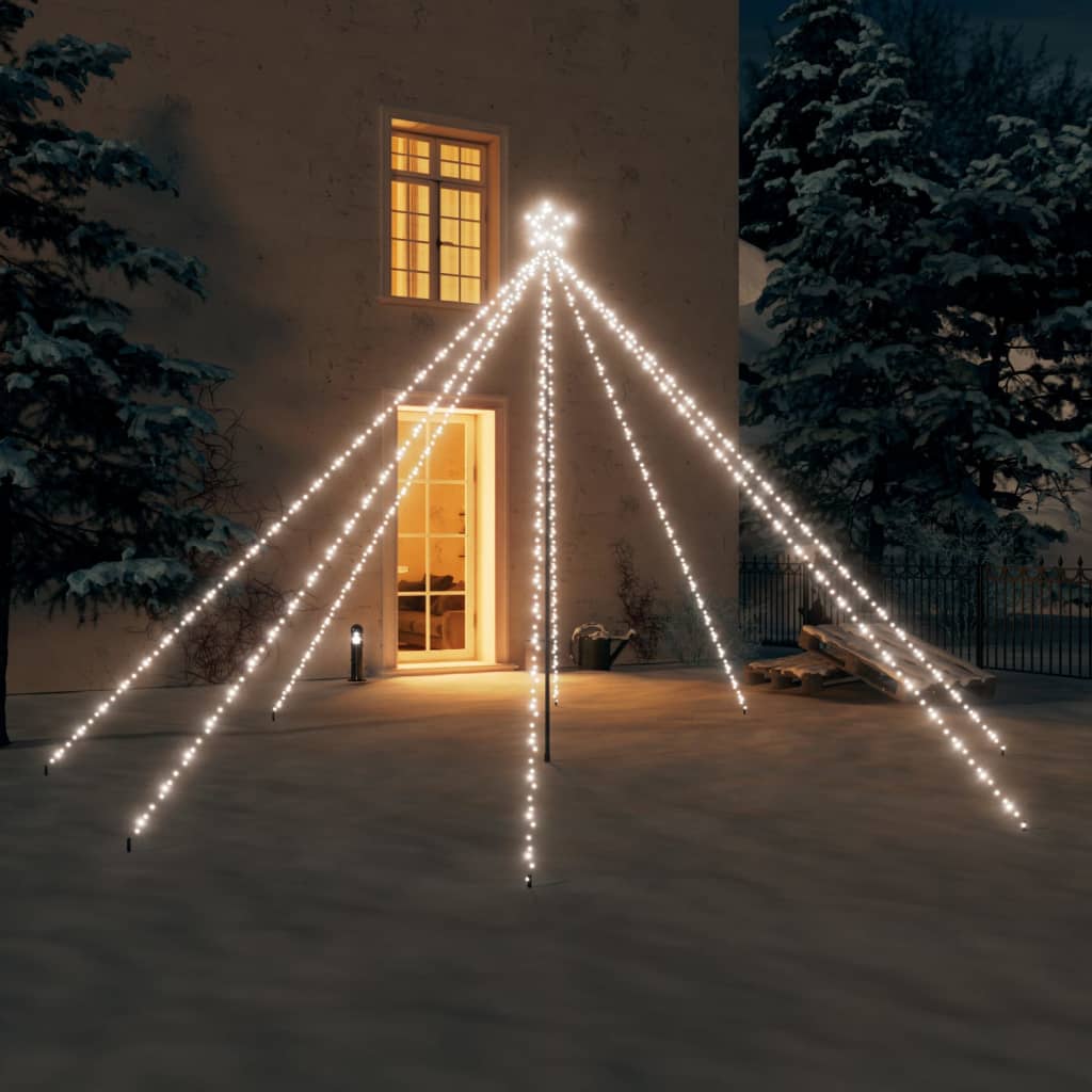 A 12ft LED Christmas tree with 576 cold white lights illuminating a snowy outdoor scene at night.