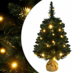 A 2-foot green PVC artificial Christmas tree pre-lit with warm LED lights on a burlap base.