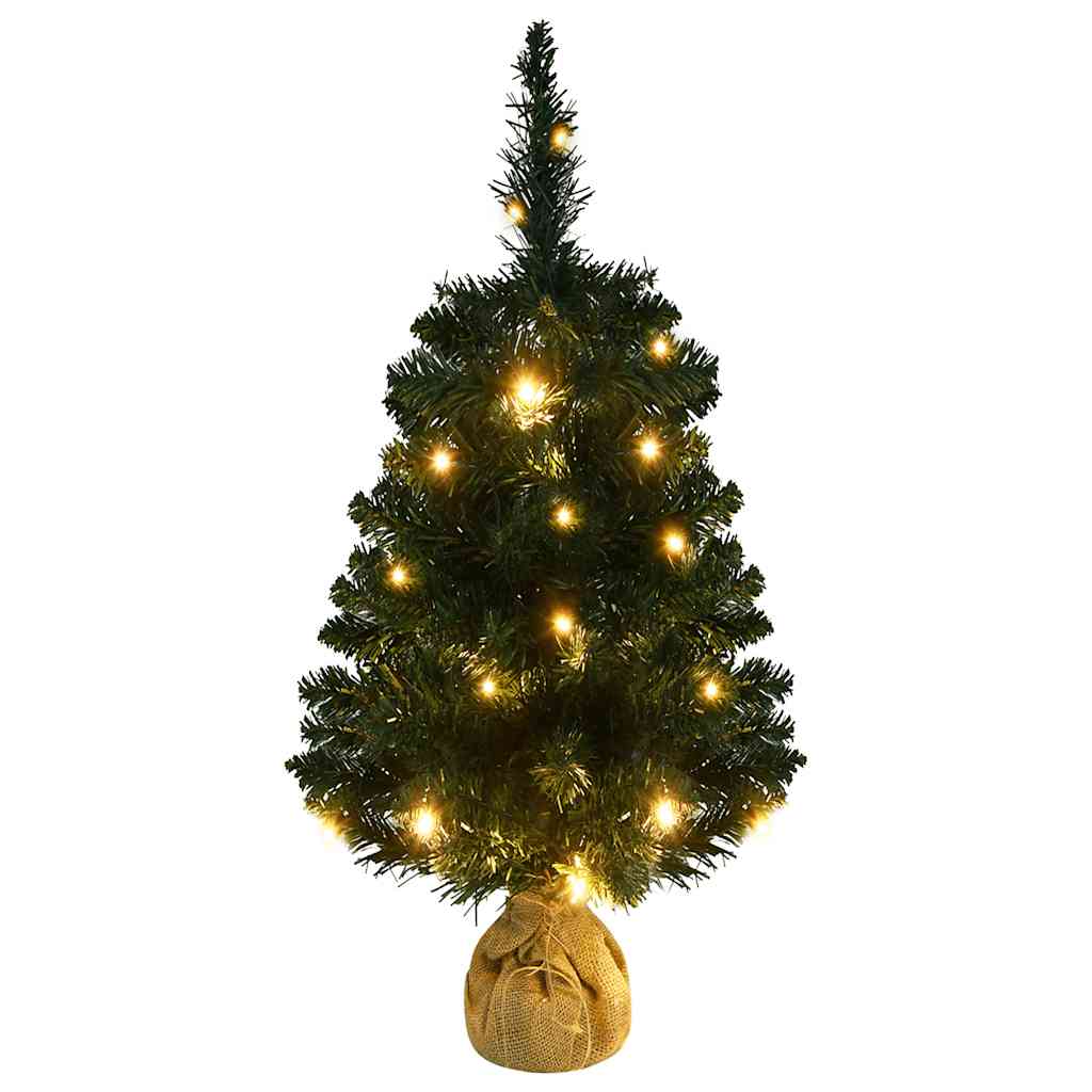 A 3 ft pre-lit artificial Christmas tree with green PVC branches and warm LED lights on a burlap stand.