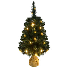 A 3 ft pre-lit artificial Christmas tree with green PVC branches and warm LED lights on a burlap stand.
