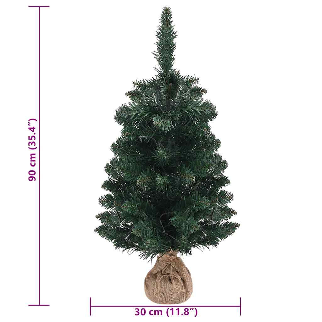 3 ft pre-lit artificial Christmas tree in green PVC with burlap base and size markings.