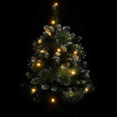 A 2-foot green PVC artificial Christmas tree with snow flocking and warm LED lights.