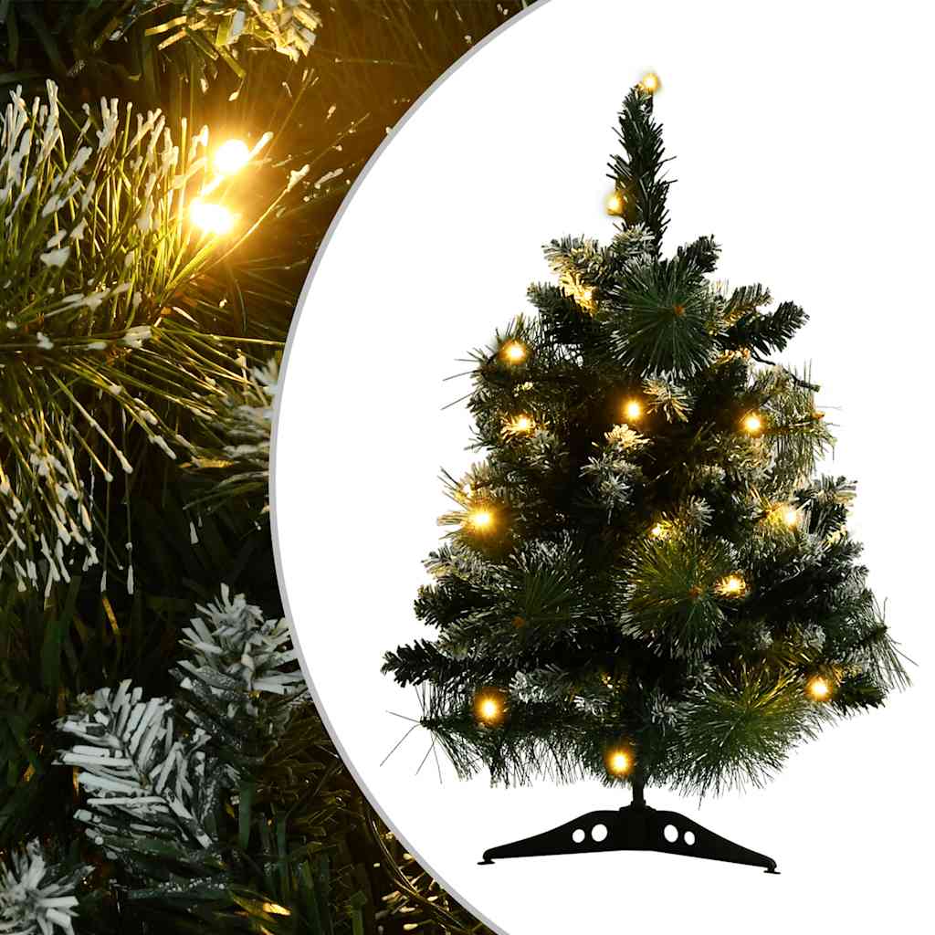 A 2-foot green PVC snow-flocked artificial Christmas tree with pre-lit warm LED lights and a sturdy stand.