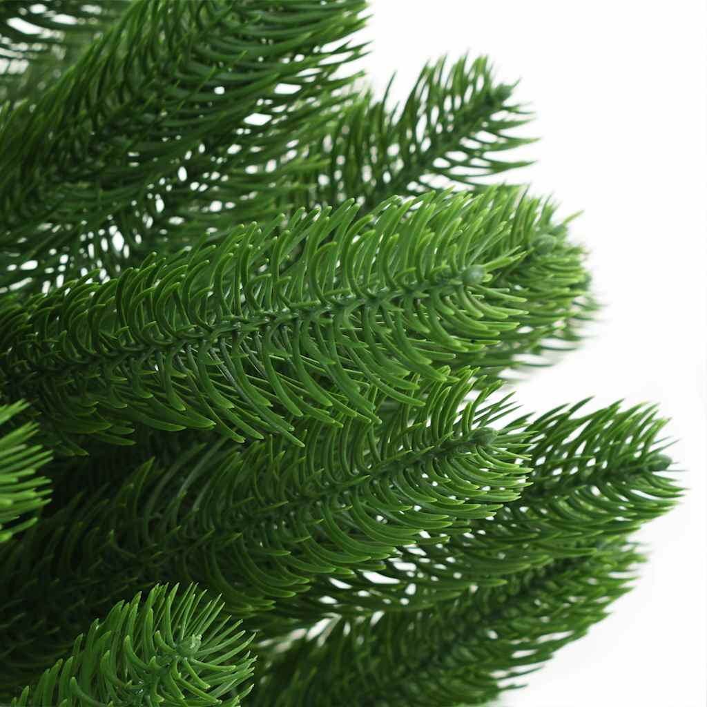 Close-up of green artificial pine branches from a pre-lit 82.7-inch Christmas tree.