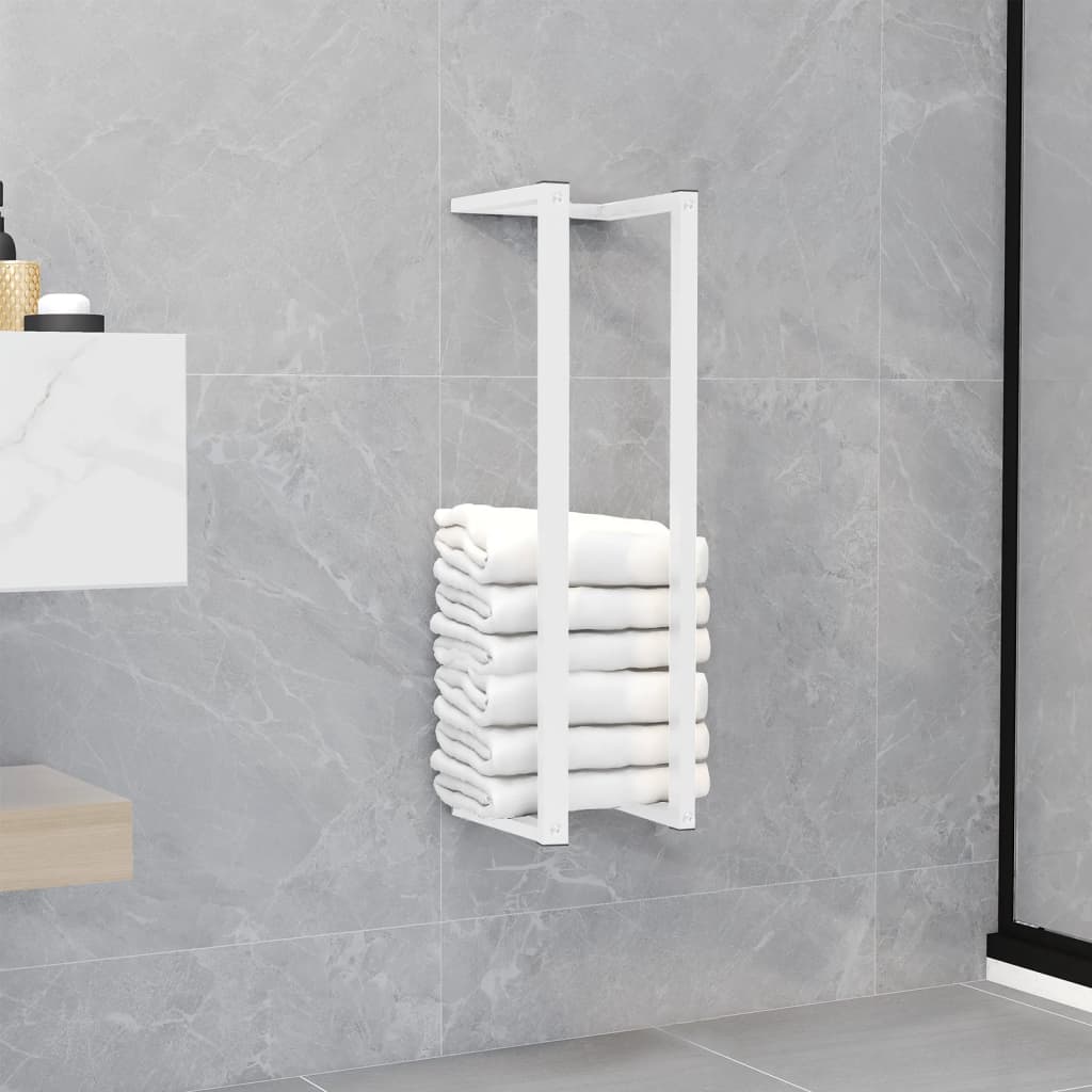 White steel towel rack mounted on bathroom wall, holding stacked white towels.