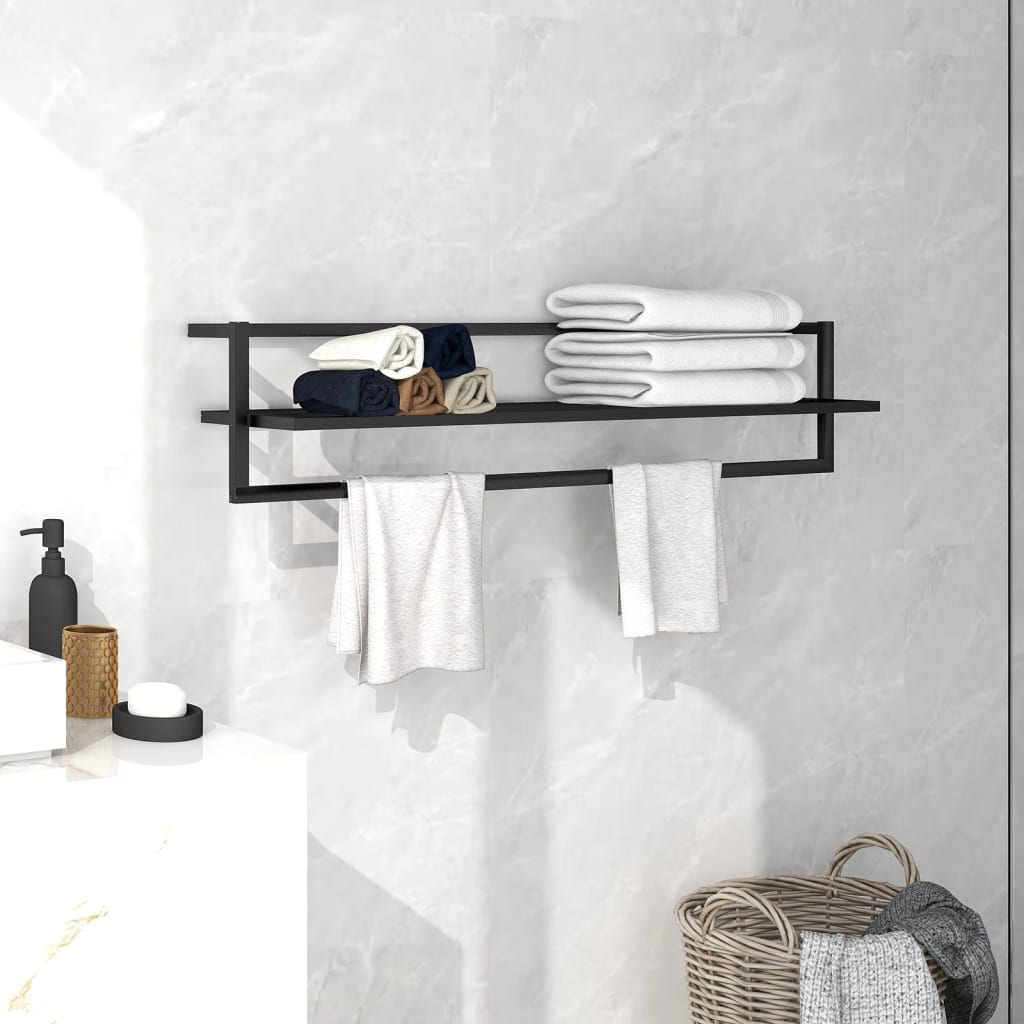 Black iron towel rack with shelf holding folded white towels, mounted on a bathroom wall.